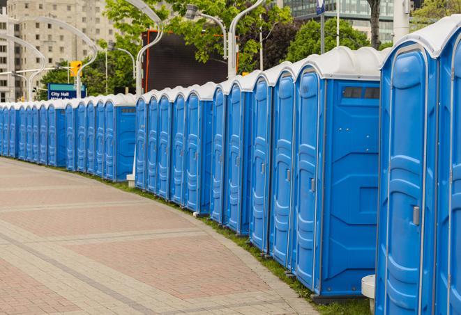 a row of portable restrooms set up for a large athletic event, allowing participants and spectators to easily take care of their needs in Anderson IN